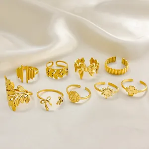 Close-up of 9-piece gold-plated titanium steel ring set on soft cream silk fabric