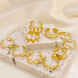 Set of 18K gold plated stainless steel rings in various textures on stone display