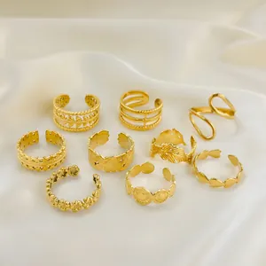 Detail of 9pcs gold stainless steel rings set with vintage patterns on white silk