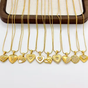 Collection of 11 golden heart pendant necklaces in varied styles on white background
