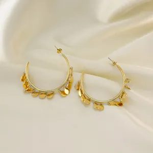 Detail van 18K vergulde roestvrijstalen oorringen met hangende ronde lovertjes decoratie