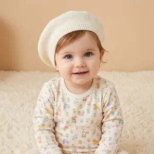 Detailed knit texture of off-white baby beret and floral animal print romper set