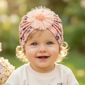 Detailed view of pink floral baby turban hat featuring a large 3D mesh flower decoration