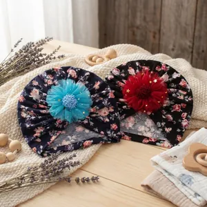 Floral baby turban hats set with large 3D mesh flowers and gold star sequins on knit rug