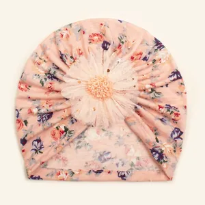 Detail of baby floral turban hat with a 3D tulle flower and gold sequin accents