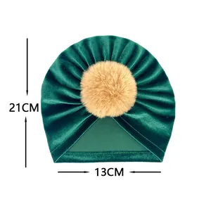 Détail du bonnet en velours vert foncé pour bébé avec mesures de 21cm sur 13cm