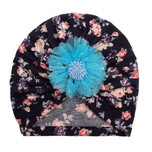 Navy floral baby turban hat with a large light blue lace flower and gold sequin accents