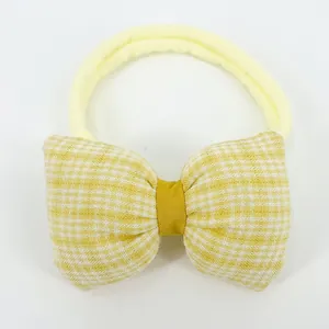 Detail of yellow checkered bow headband with high-elastic nylon band for infants