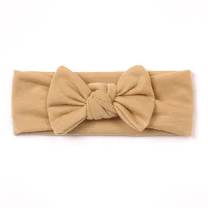 Elastic cotton baby headband in khaki with a large knotted double-layered bow