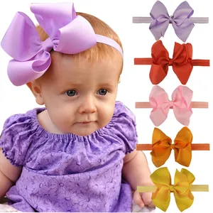Detail of soft elastic baby headbands with large ribbed fabric bows in various colors