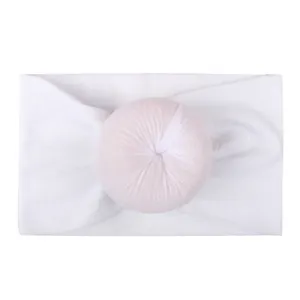 Soft white nylon baby headband featuring a decorative 3D doughnut knot design