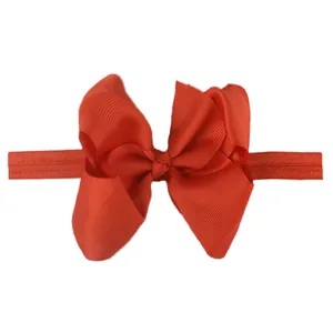 Detail of red grosgrain ribbon bow with high-elastic seamless headband for infants