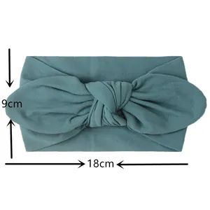 Teal nylon baby turban headband with big bow detailing and 18cm by 9cm dimensions