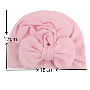 Detailed dimensions of pink infant turban hat with large bow measuring 17cm by 18cm
