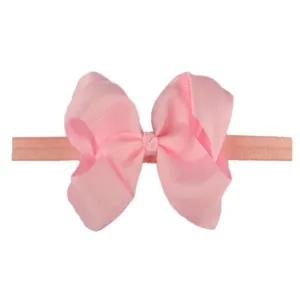 Close-up of baby girl soft elastic headband with light pink grosgrain ribbon bow
