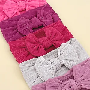 Set of six colorful baby headbands with large bows and elastic cable knit texture