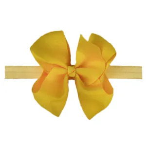 Close-up of bright yellow grosgrain ribbon bow with a soft elastic headband for infants