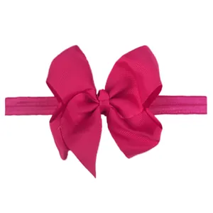 Close-up of a rose red grosgrain ribbon bow headband with elastic seamless band