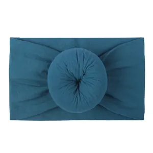Soft nylon baby headband with a donut knot design in a deep peacock blue color