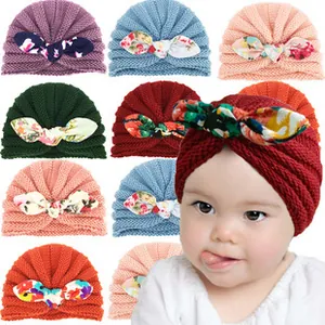 Detail of baby turban hats with colorful floral bows in various color options