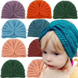 Close-up of 8 colorful ribbed knit baby turbans featuring soft knotted flower designs