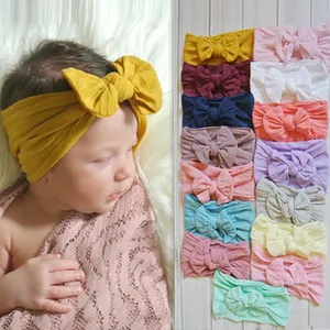 Soft elastic baby headband set with large bow detail shown in fifteen vibrant colors
