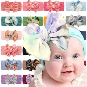 Close-up of baby knotted rabbit ear headbands in various colors and floral patterns