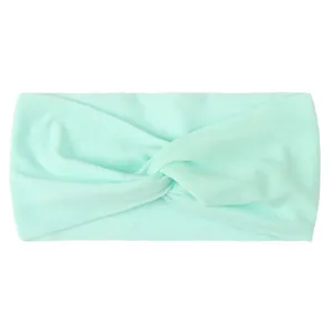 Detail of light mint green knitted nylon hair band with a soft twist knot texture