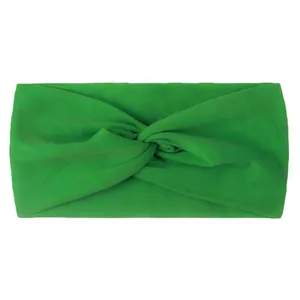 Detail of bright green nylon knotted headband showing high-stretch knit fabric texture