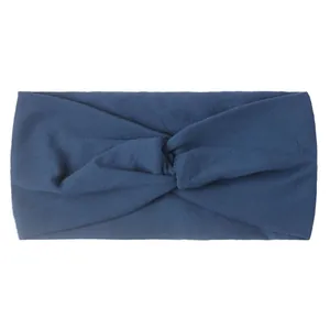 Detail of soft navy blue wide knotted nylon headband for baby girls with elastic knit texture