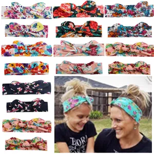 Detail of floral print baby headbands with rabbit ear bows in various colors