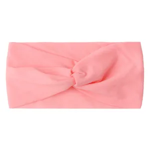 Detailed view of pink knotted baby headband made from soft elastic nylon fabric