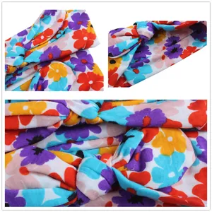 Detail view of floral print knot headband showing soft knit fabric and colorful patterns