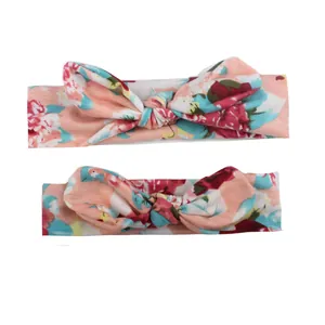 Floral print baby headbands with rabbit ear knots in soft pink stretch fabric