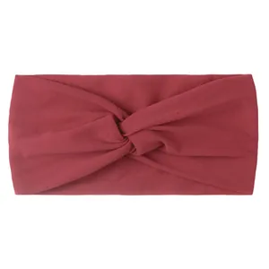 Detail of dark red knotted baby hair band showing soft ribbed knit fabric texture