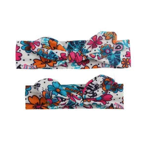 Matching floral rabbit ear headbands for parent and baby in vibrant floral print pattern