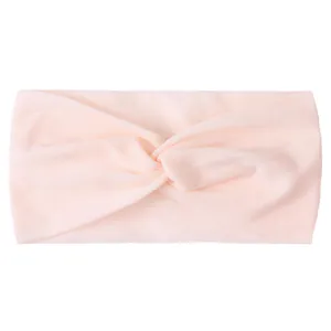 Detail of soft pink twisted nylon headband for babies with plush velvet texture