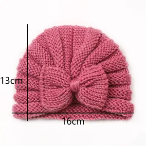 Detailed dimensions of hot pink knit baby hat with bow, measuring 13cm by 16cm size