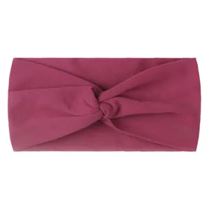 Detail of the soft elastic fabric texture and twisted knot design on the magenta headband
