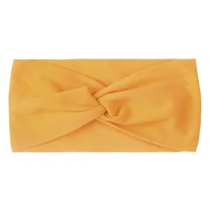Close-up of orange twisted nylon hair band showing soft knitted texture and elastic design