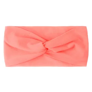 Close-up of coral pink nylon headband with a knotted twist and soft knit texture