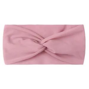 Detail of pink knotted nylon baby headband featuring soft stretchable fabric texture