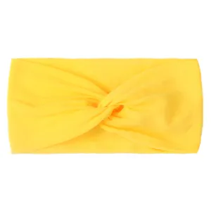 Detail view of a bright yellow knotted nylon hair band with soft ribbed texture