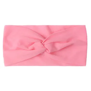 Close-up of bright pink nylon twisted knot headband with soft breathable texture