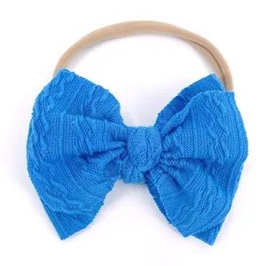 Bandeau bébé sans couture avec grand nœud jacquard bleu roi en tissu tricoté