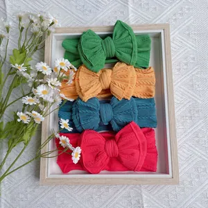 Set of 4 nylon cable knit baby headbands with large double layer bows in vibrant colors
