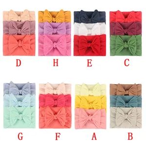 Detailed close-up of 3-piece sets of elastic nylon baby bow headbands in vibrant colors