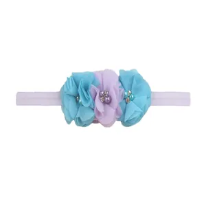 Detailed view of elastic baby headband with blue and purple chiffon flowers and pearls