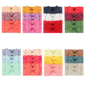 Detail view of colorful 3-piece nylon bow headbands set with elastic fabric for infants