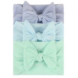 3-piece set of elastic nylon baby headbands with large bows in soft pastel colors